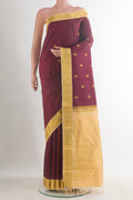 Pure Silk Maroon Kanjivaram Saree with Zari Butta on the body and Zari Border.  displayed on a mannequin