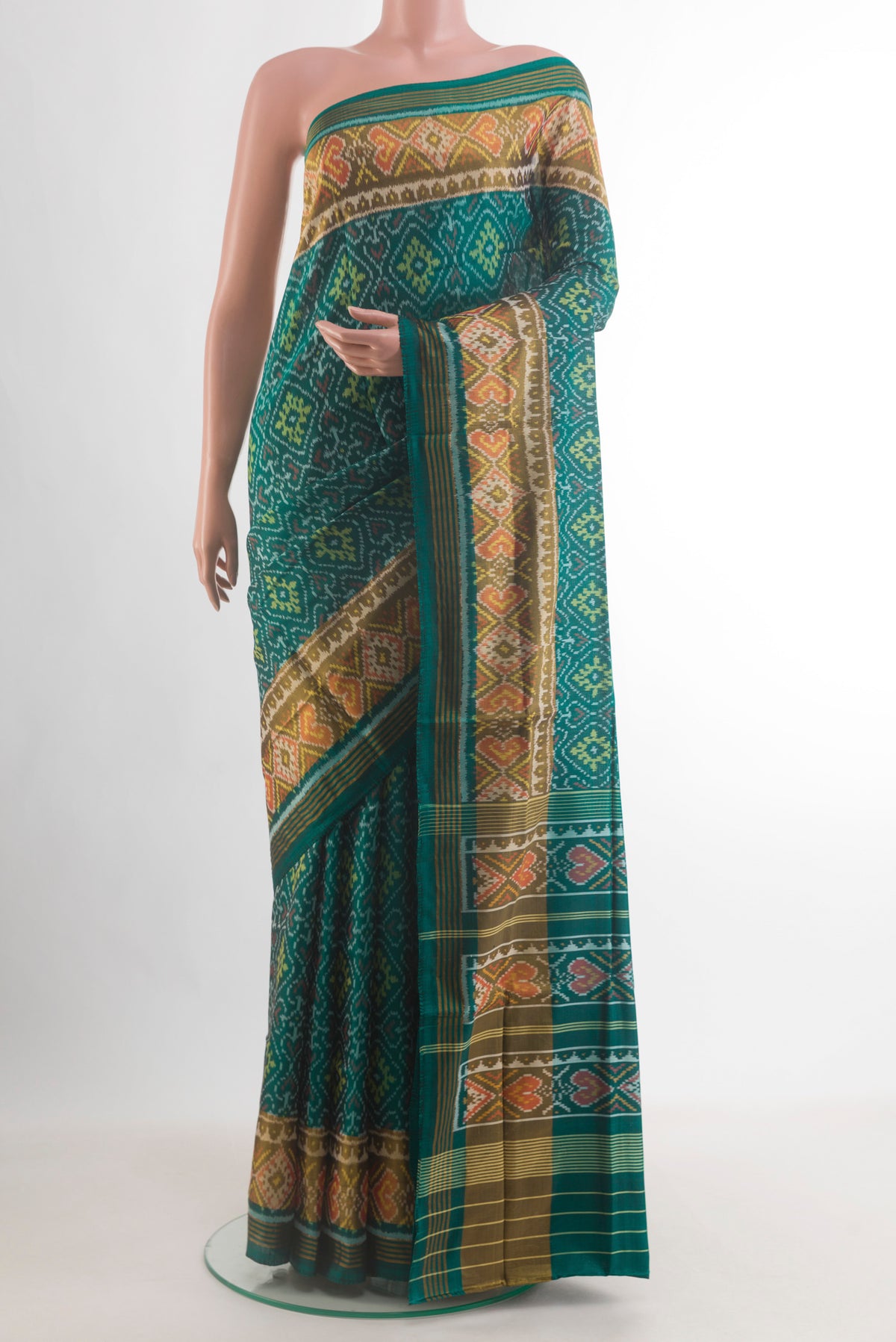 Pure Silk Green Rajkot Patola Saree with Pure Ikat on the body and Ikat Border.  displayed on a mannequin