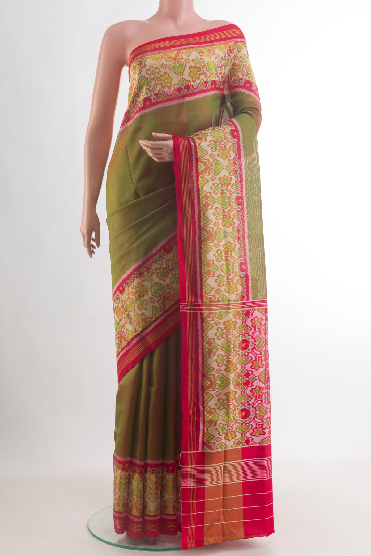 Pure Silk Green Rajkot Patola Saree with Plain Body and Ikat Border.  displayed on a mannequin