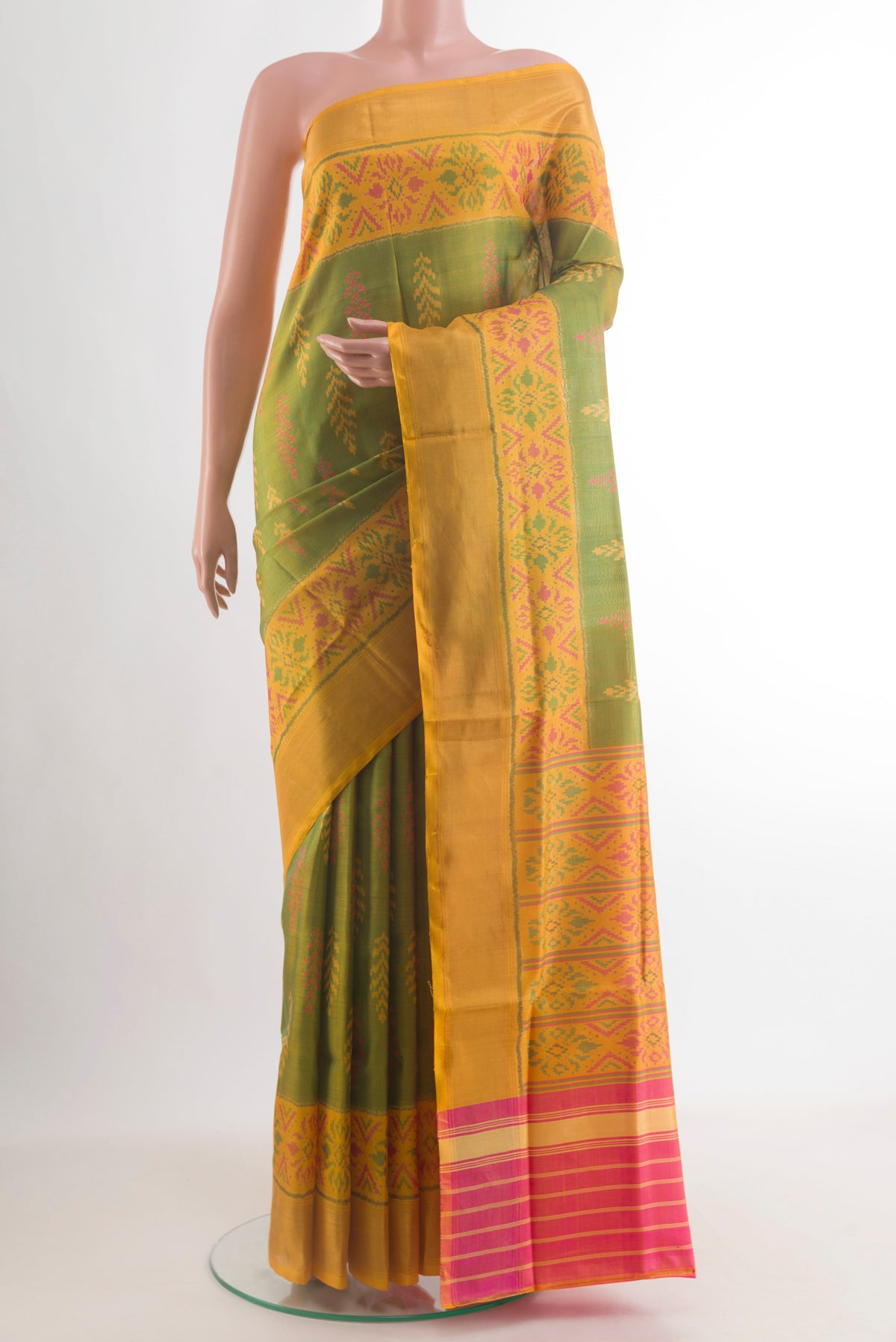 Pure Silk Green Rajkot Patola Saree with Pure Ikat on the body and Ikat Border.  displayed on a mannequin