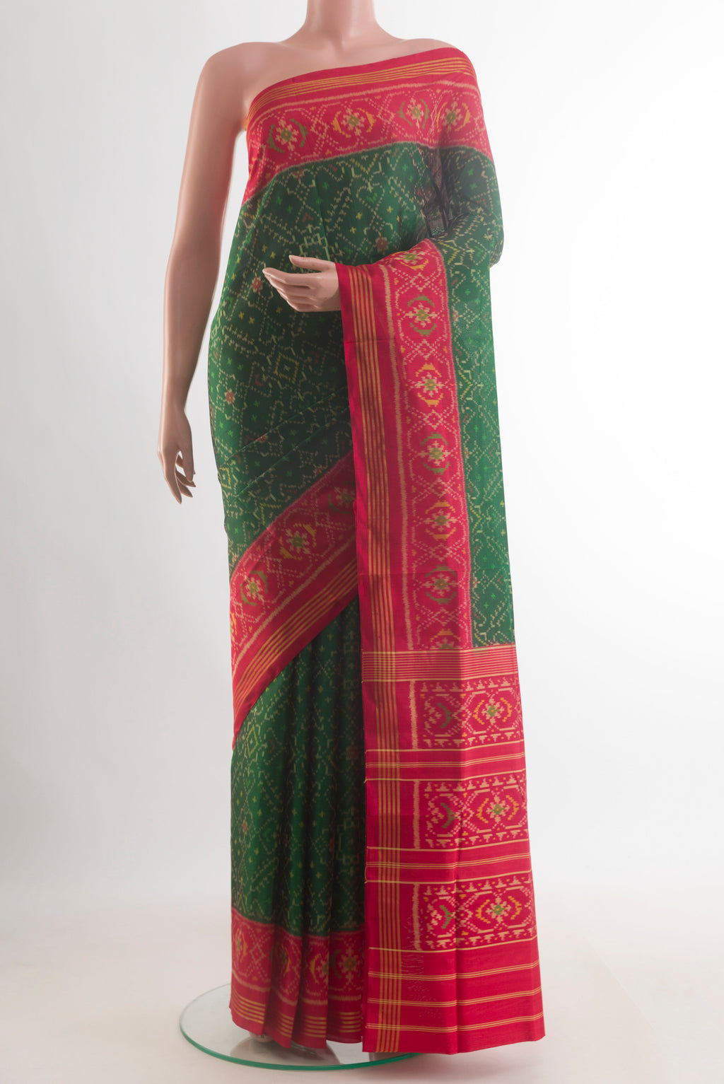 Pure Silk Green Rajkot Patola Saree with Pure Ikat on the body and Zari Border.  displayed on a mannequin