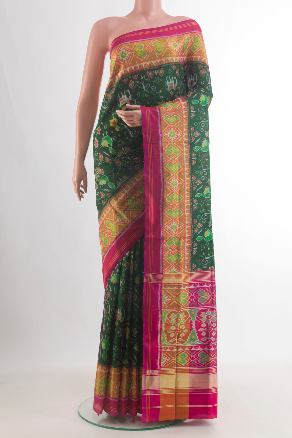 Pure Silk Bottle Green Rajkot Patola Saree with Pure Ikat on the body and Ikat Border.  displayed on a mannequin