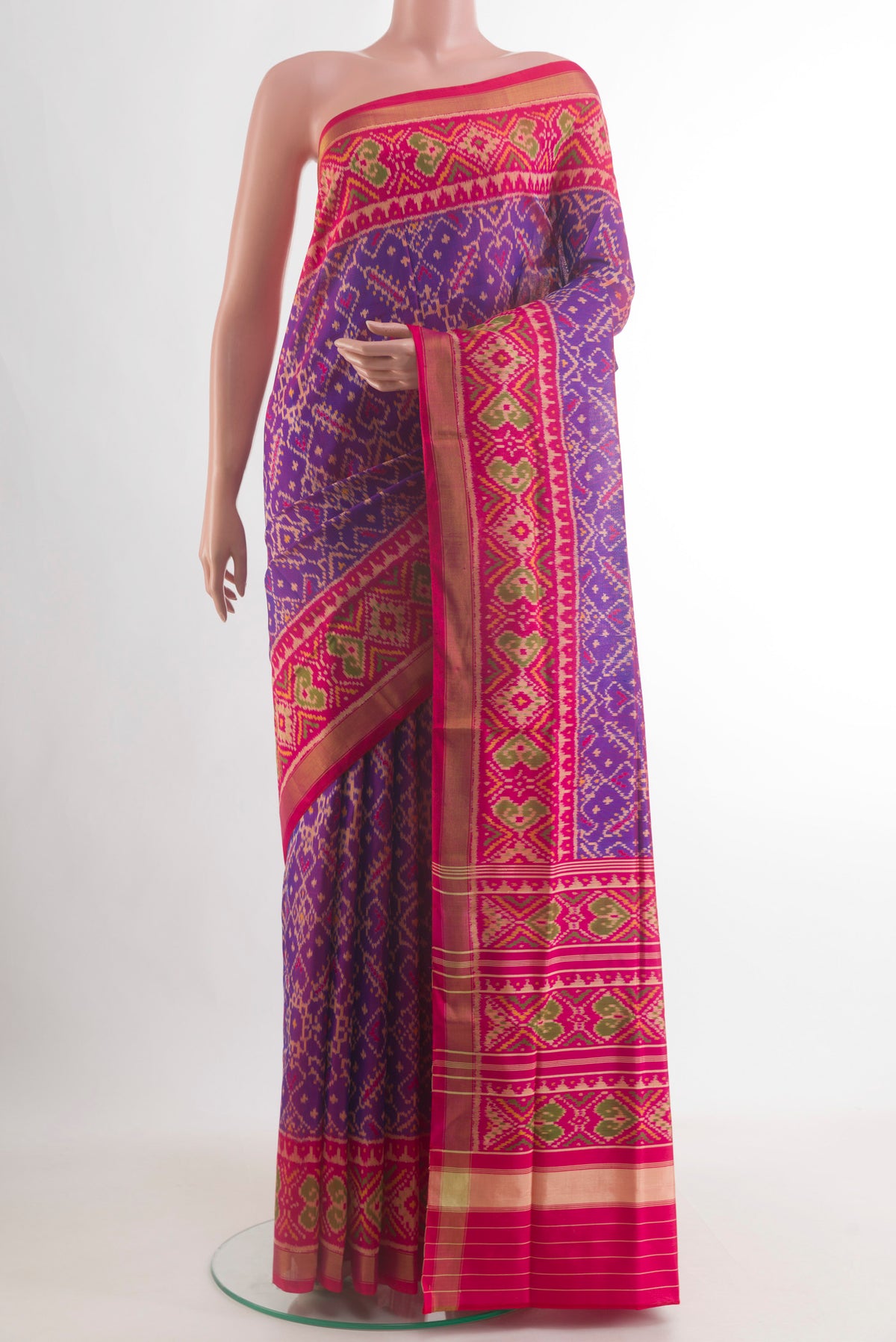 Pure Silk Purple Rajkot Patola Saree with Pure Ikat on the body and Ikat Border.  displayed on a mannequin