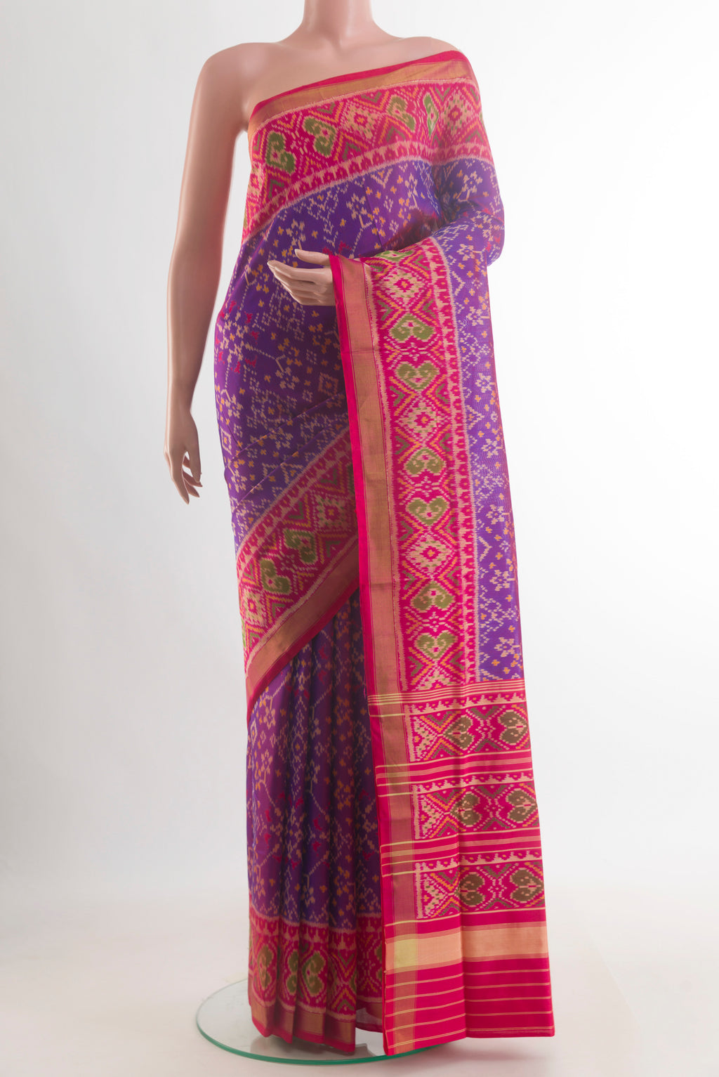 Pure Silk Purple Rajkot Patola Saree with Pure Ikat on the body and Ikat Border.  displayed on a mannequin
