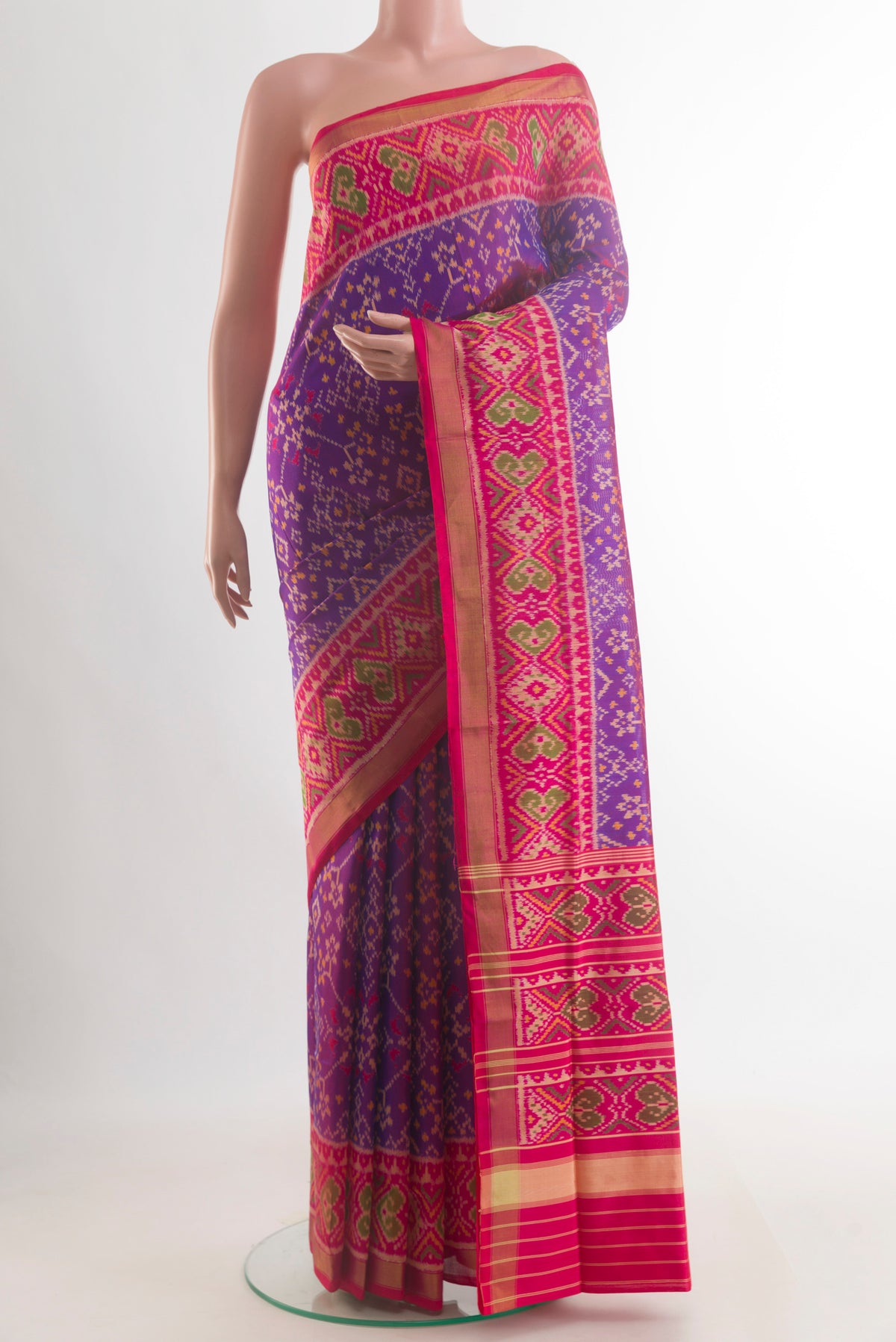 Pure Silk Purple Rajkot Patola Saree with Pure Ikat on the body and Ikat Border.  displayed on a mannequin