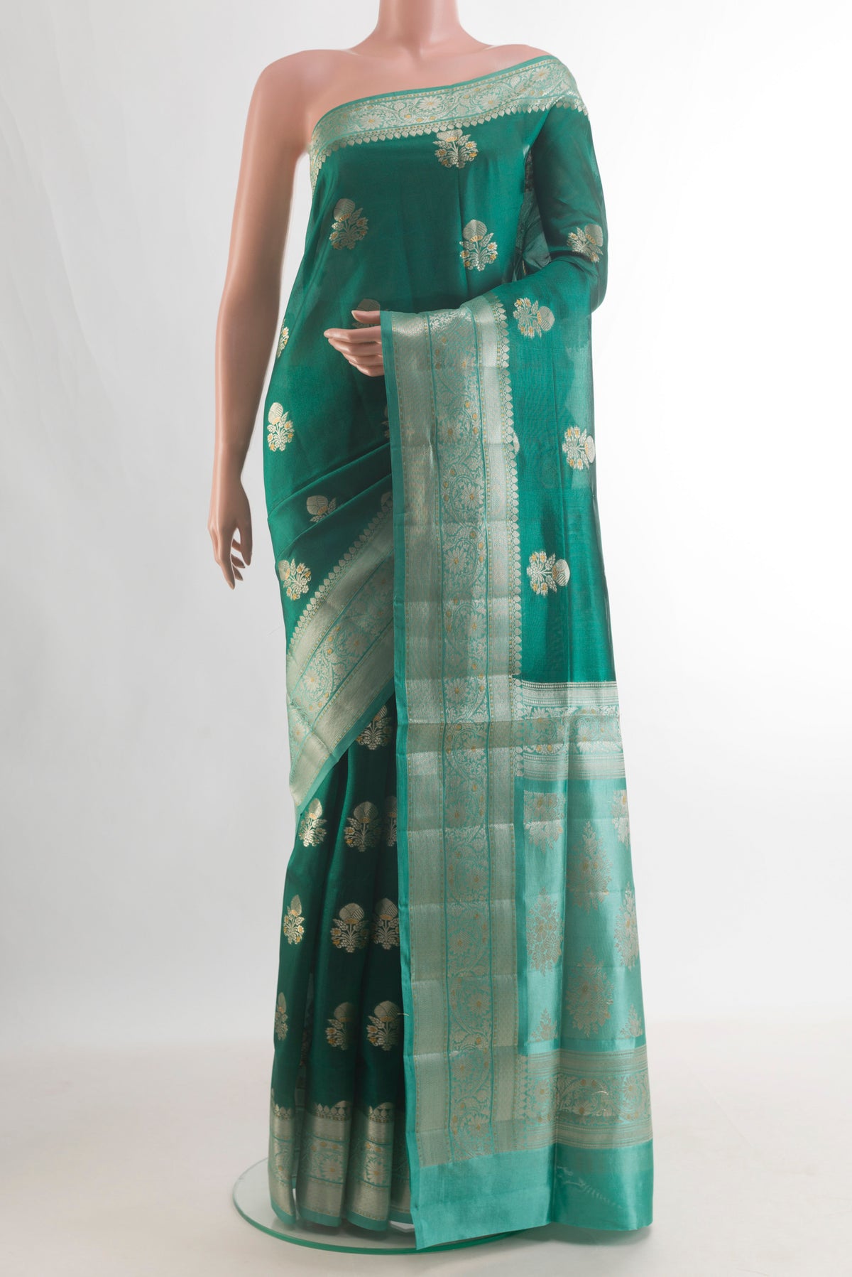 Pure Silk Green Banarasi Raw Saree with Zari Butta on the body and Zari Border.  displayed on a mannequin