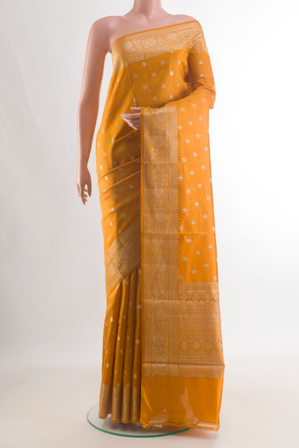 Pure Silk Yellow Banarasi Raw Saree with Zari Butta on the body and Zari Border.  displayed on a mannequin