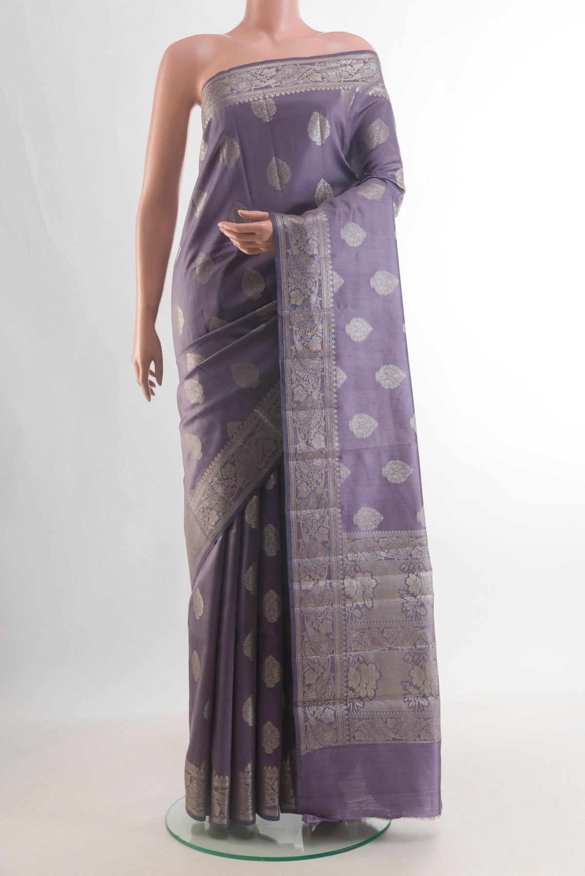 Pure Silk Davys Grey Banarasi Raw Saree with Zari Butta on the body and Zari Border.  displayed on a mannequin