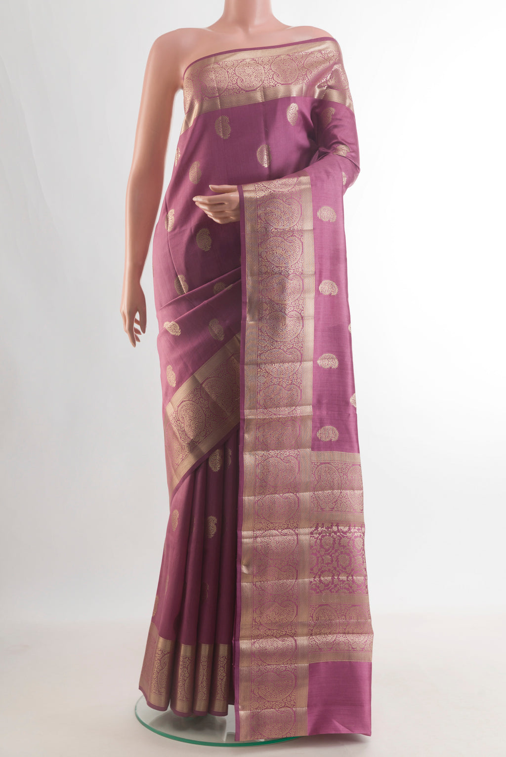 Pure Silk Mauve Banarasi Raw Saree with Zari Butta on the body and Zari Border.  displayed on a mannequin