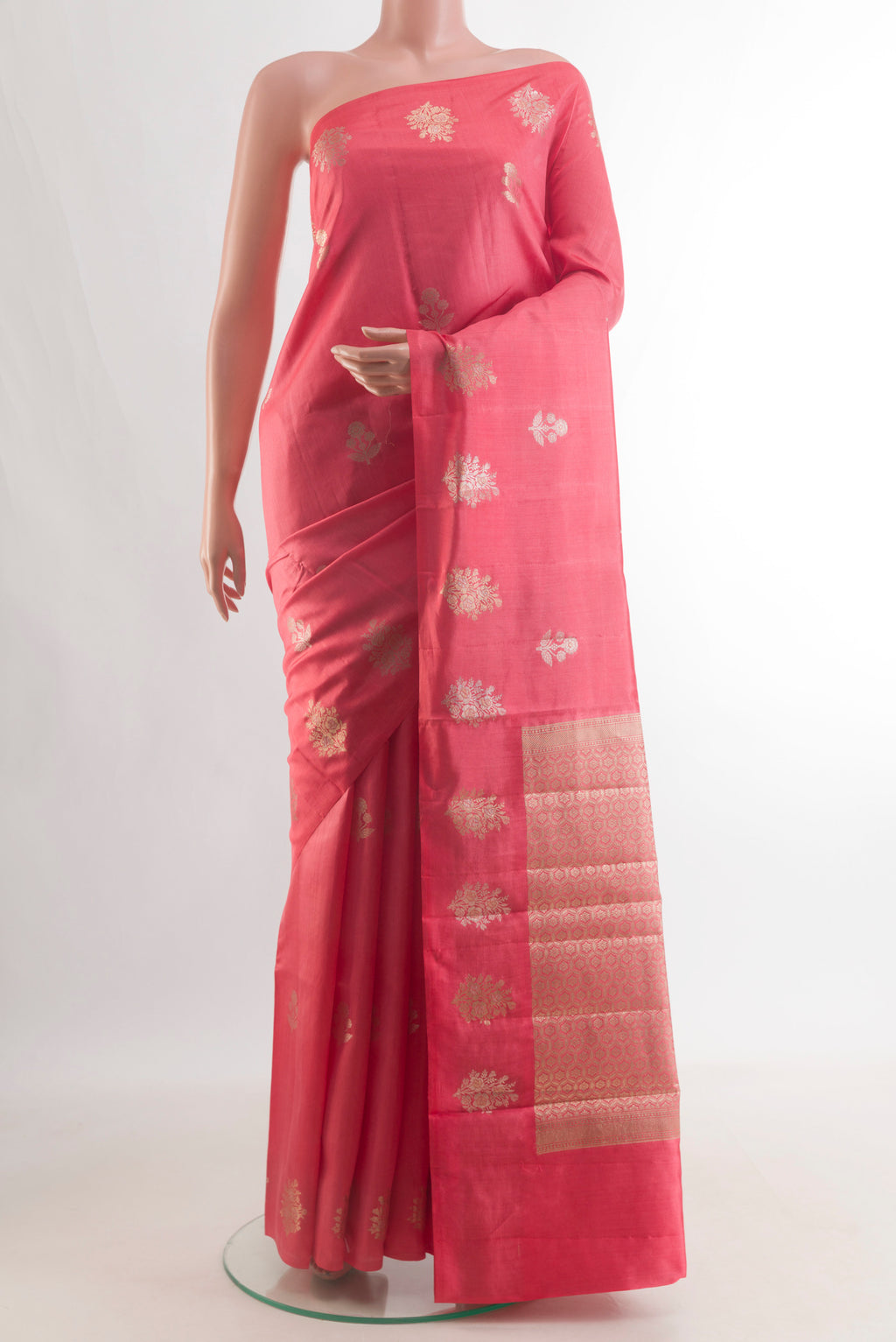 Pure Silk Coral Banarasi Raw Saree with Zari Butta on the body and Zari Border.  displayed on a mannequin