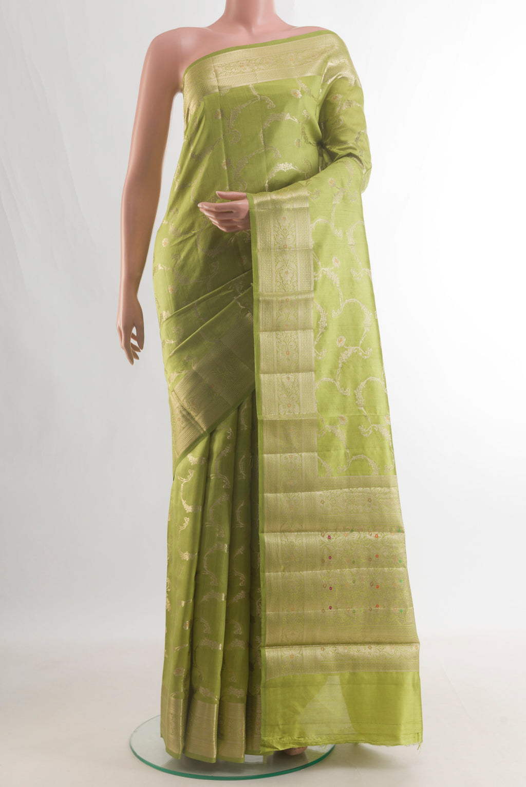 Pure Silk Green Banarasi Raw Saree with Zari Brocade on the body and Zari Border.  displayed on a mannequin