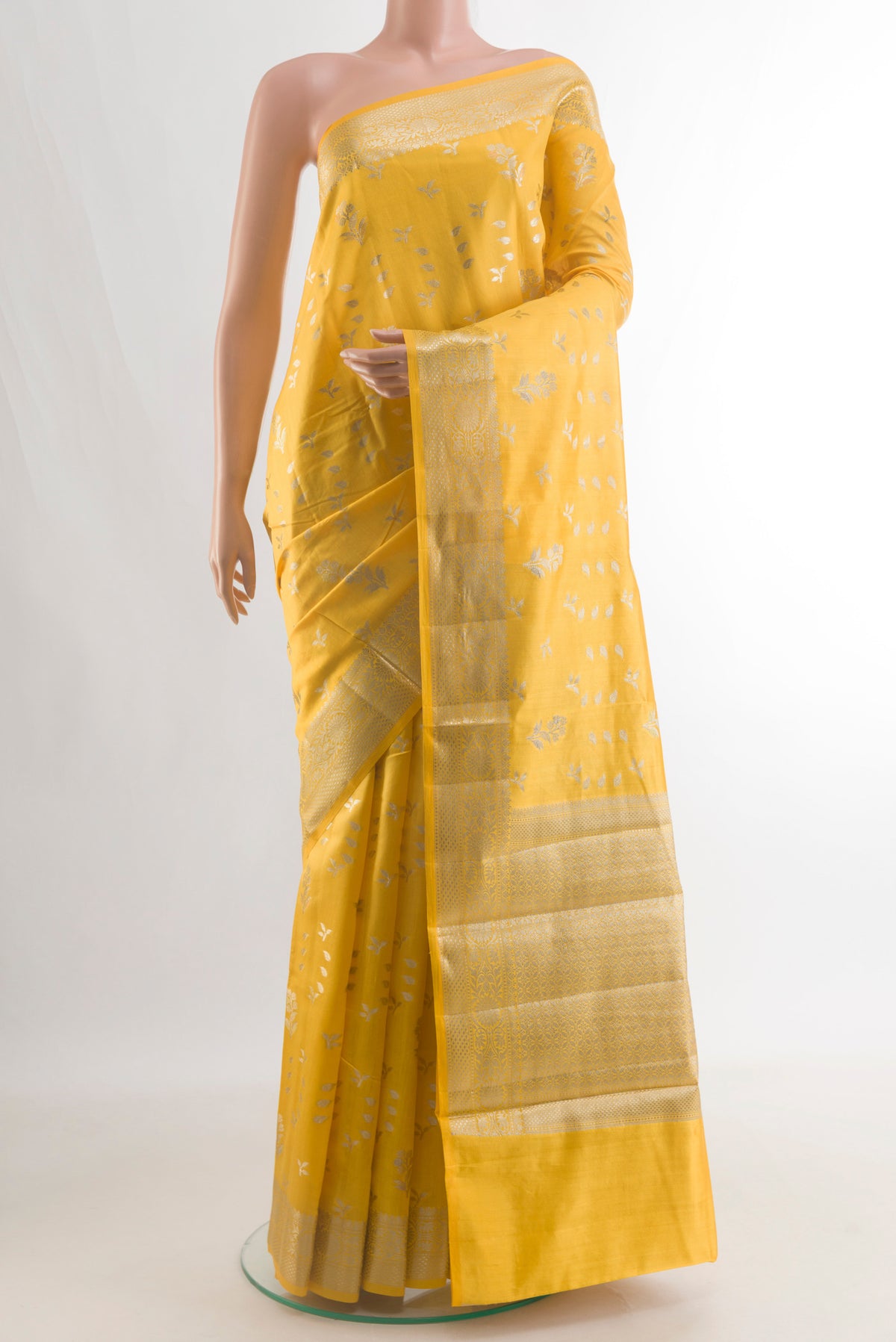 Pure Silk Yellow Banarasi Raw Saree with Zari Butta on the body and Zari Border.  displayed on a mannequin