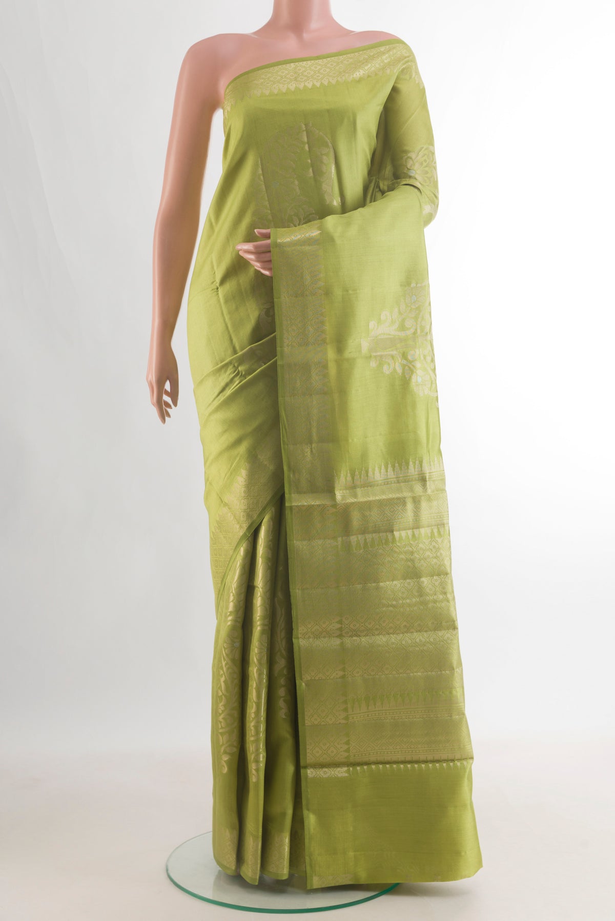 Pure Silk Green Banarasi Raw Saree with Zari Butta on the body and Zari Border.  displayed on a mannequin
