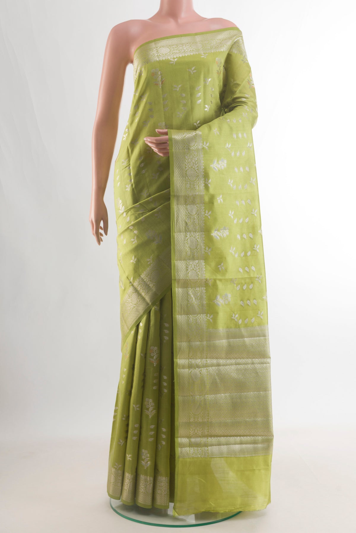 Pure Silk Green Banarasi Raw Saree with Zari Butta on the body and Zari Border.  displayed on a mannequin