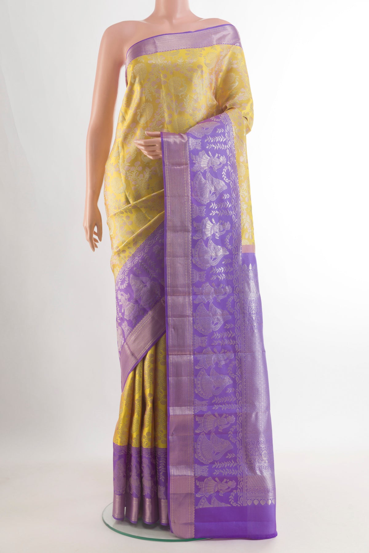Yellow Kanchipuram Tissue Saree with Zari Brocade on the body and Zari Border.  displayed on a mannequin