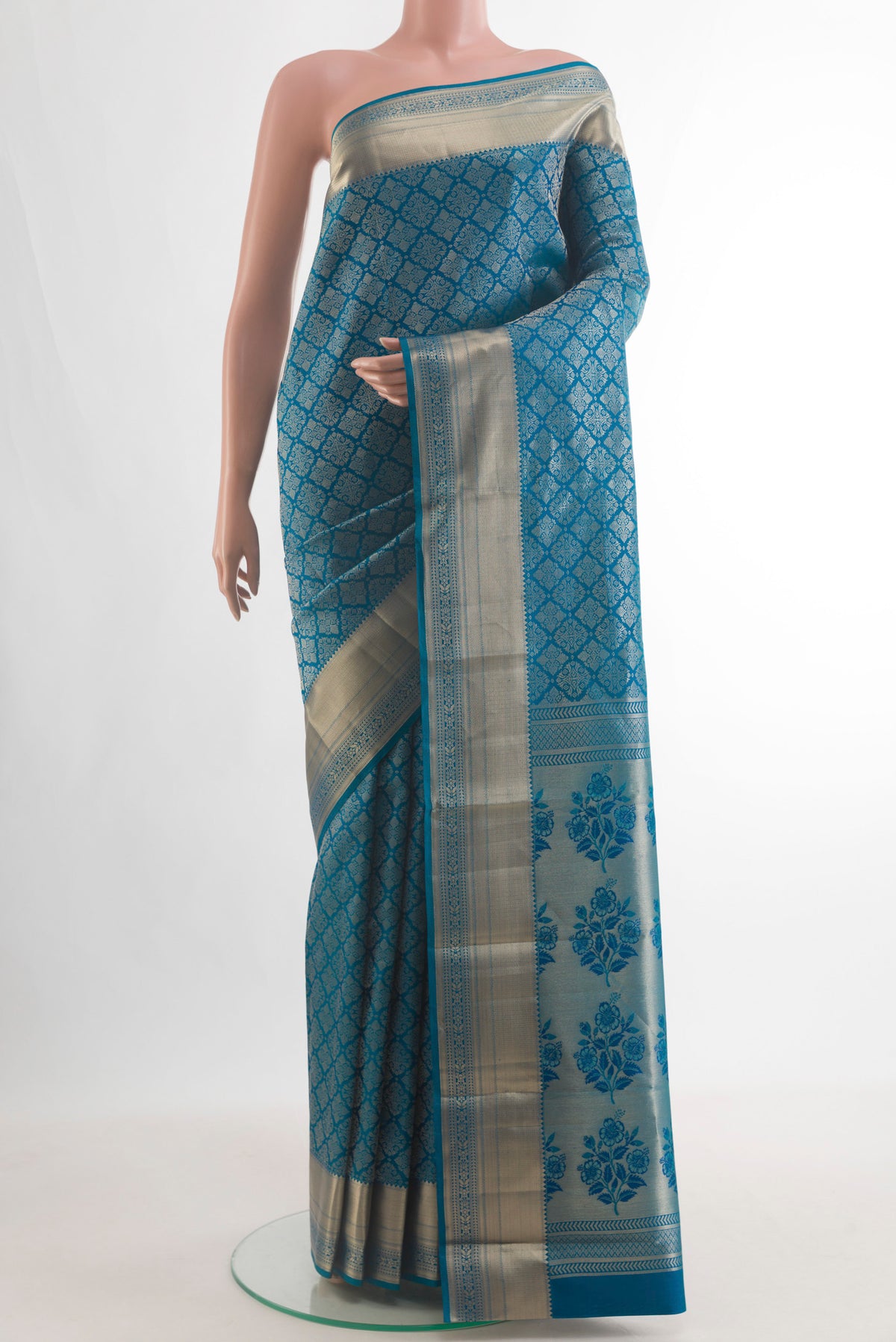 Pure Silk Peacock Blue Kanjivaram Saree with Zari Brocade on the body and Zari Border.  displayed on a mannequin