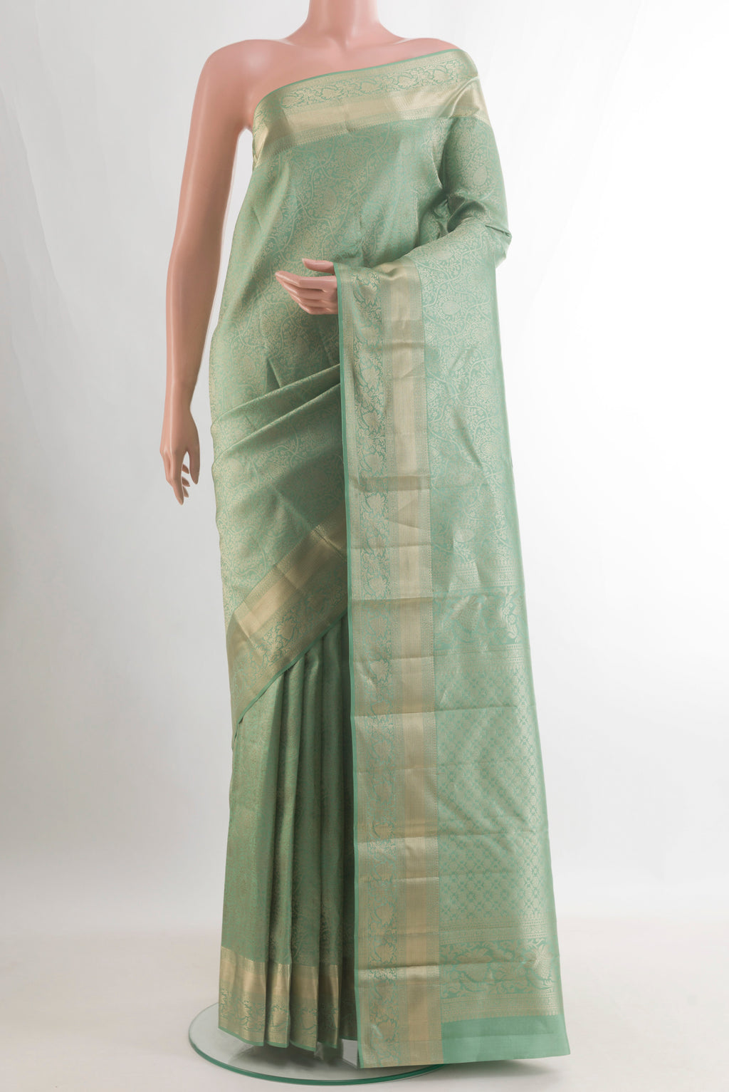 Pure Silk Mint Green Kanjivaram Saree with Zari Brocade on the body and Zari Border.  displayed on a mannequin