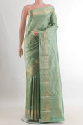 Pure Silk Mint Green Kanjivaram Saree with Zari Brocade on the body and Zari Border.  displayed on a mannequin