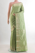 Pure Silk Pista Green Kanjivaram Saree with Zari Brocade on the body and Zari Border.  displayed on a mannequin