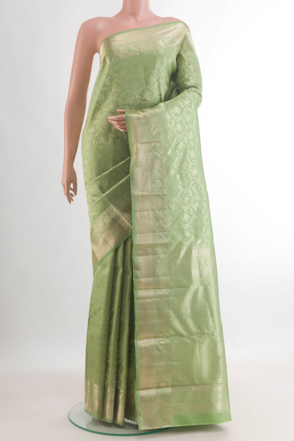 Pure Silk Pista Green Kanjivaram Saree with Zari Brocade on the body and Zari Border.  displayed on a mannequin