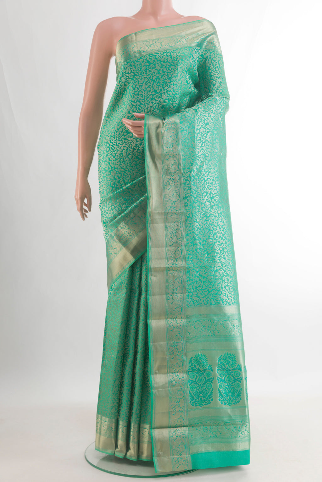 Pure Silk Sea Green Kanjivaram Saree with Zari Brocade on the body and Zari Border.  displayed on a mannequin