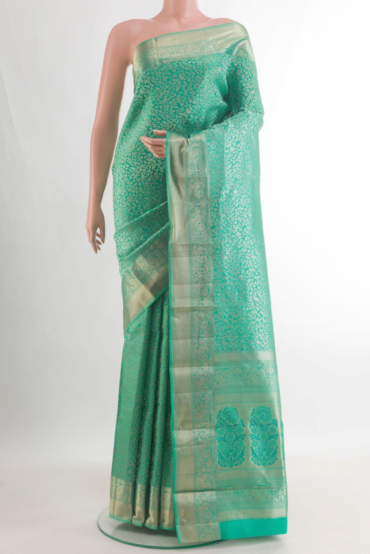 Pure Silk Sea Green Kanjivaram Saree with Zari Brocade on the body and Zari Border.  displayed on a mannequin