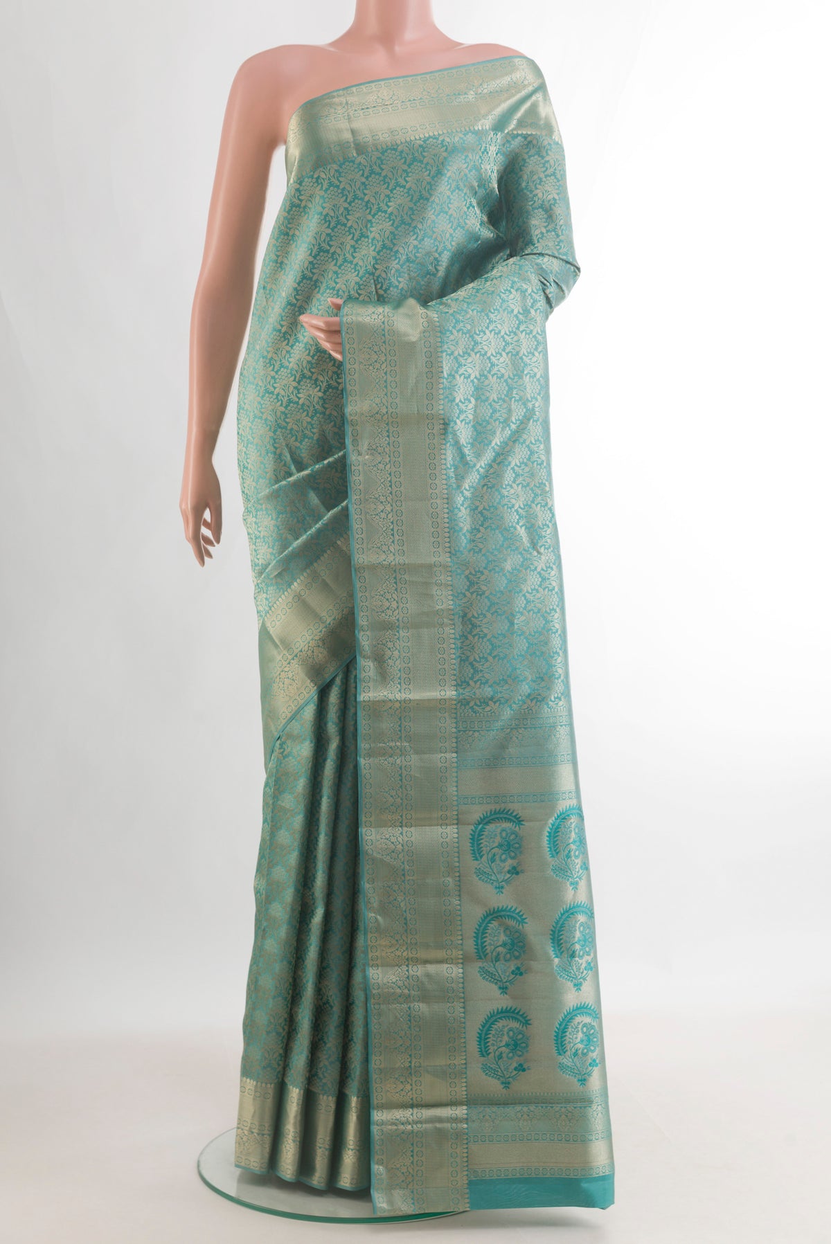 Pure Silk Turquoise Kanjivaram Saree with Zari Brocade on the body and Zari Border.  displayed on a mannequin