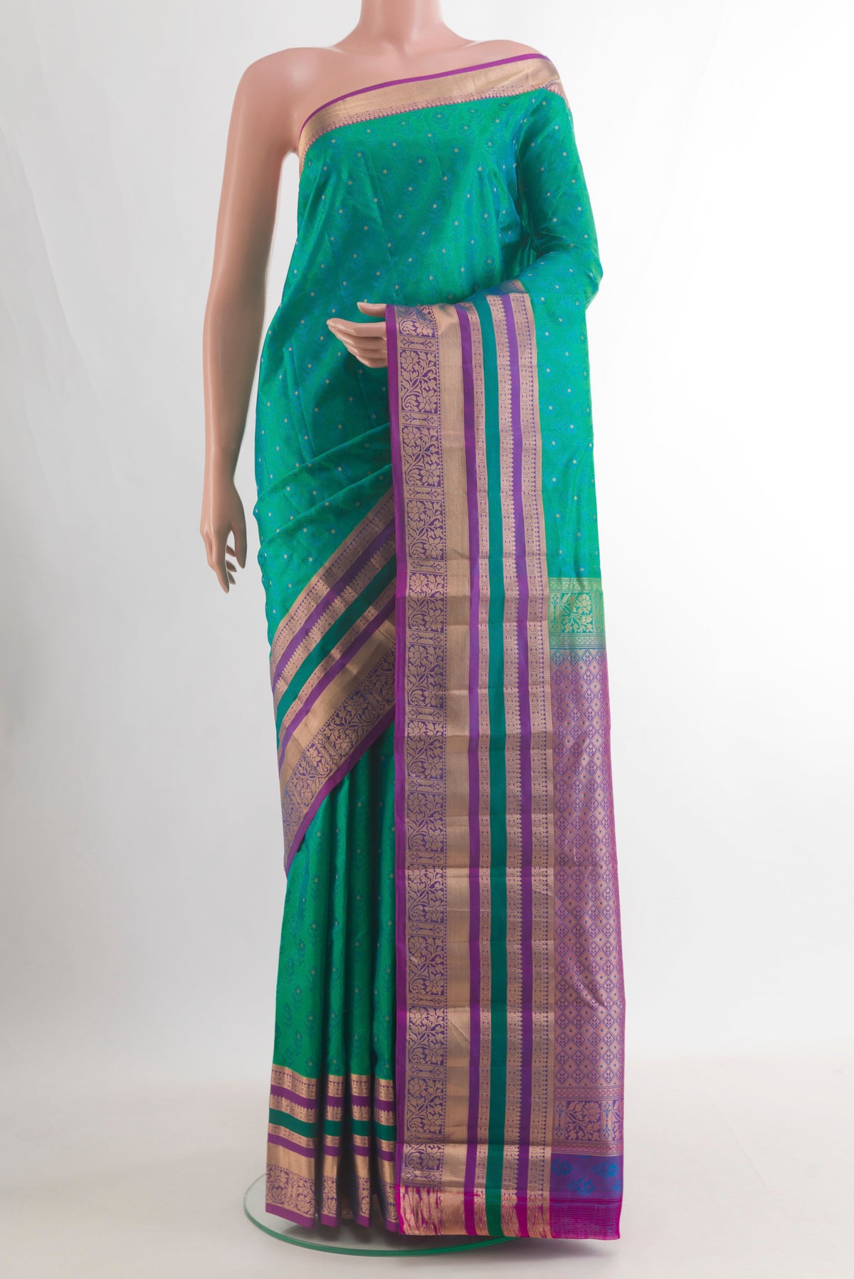 Pure Silk Green Kanjivaram Saree with Jacquard With Zari Butta on the body and Zari Border.  displayed on a mannequin