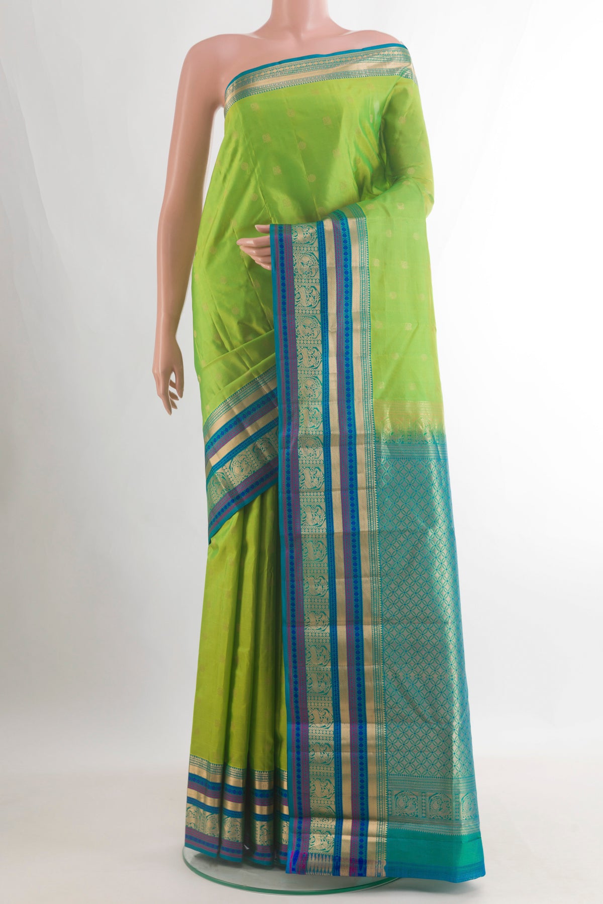Pure Silk Parrot Green Kanchipuram Saree with Zari Butta on the body and Zari Border.  displayed on a mannequin