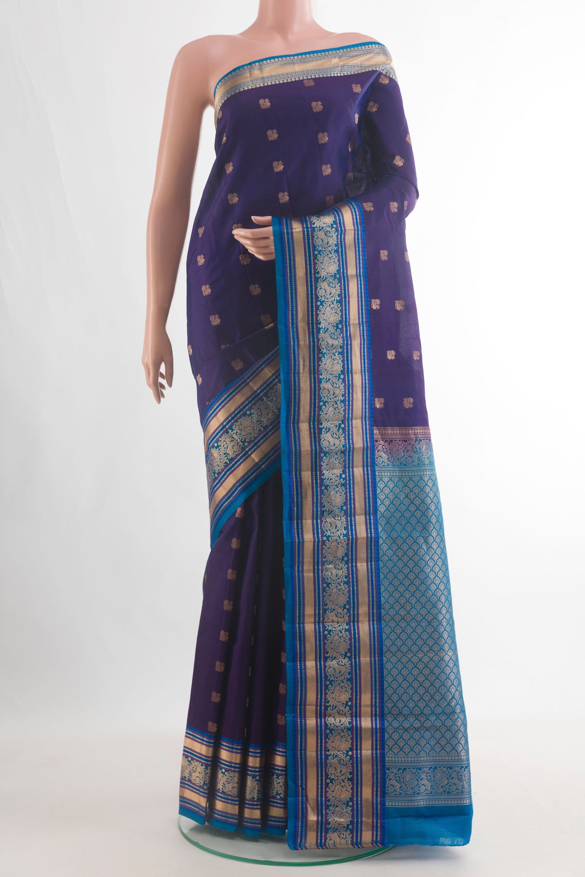 Pure Silk Navy Blue Kanchipuram Saree with Zari Butta on the body and Zari Border.  displayed on a mannequin