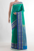 Pure Silk Green Kanchipuram Saree with Zari Butta on the body and Zari Border.  displayed on a mannequin