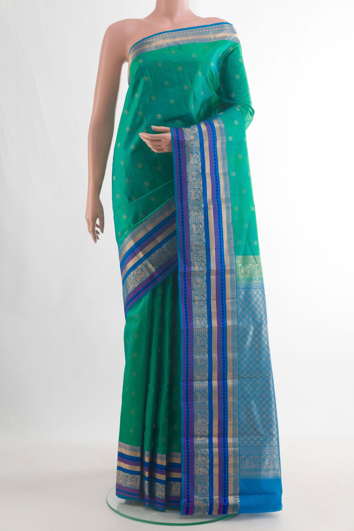Pure Silk Green Kanchipuram Saree with Zari Butta on the body and Zari Border.  displayed on a mannequin