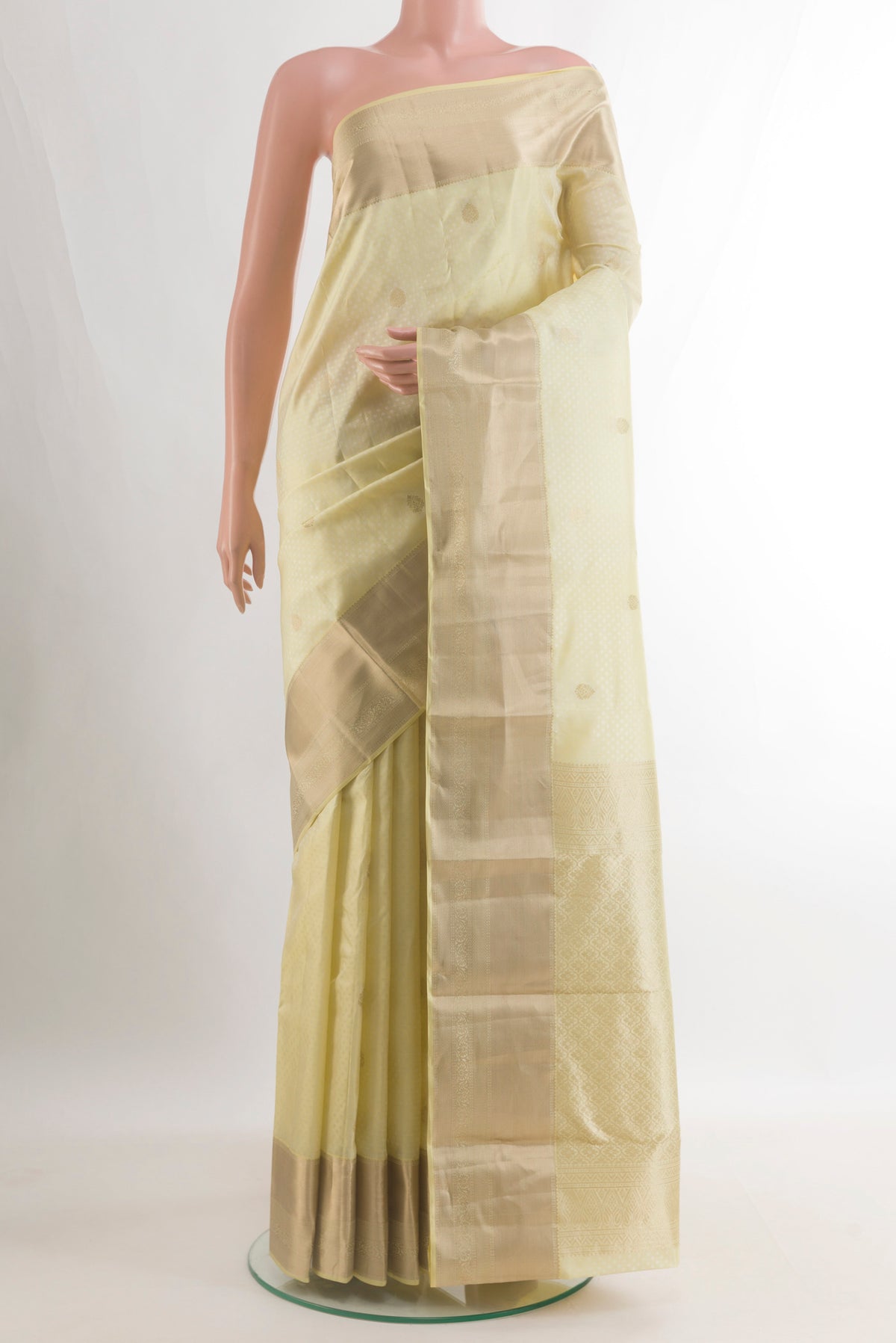Pure Silk Cream Kanchipuram Saree with Jacquard With Zari Butta on the body and Zari Border.  displayed on a mannequin