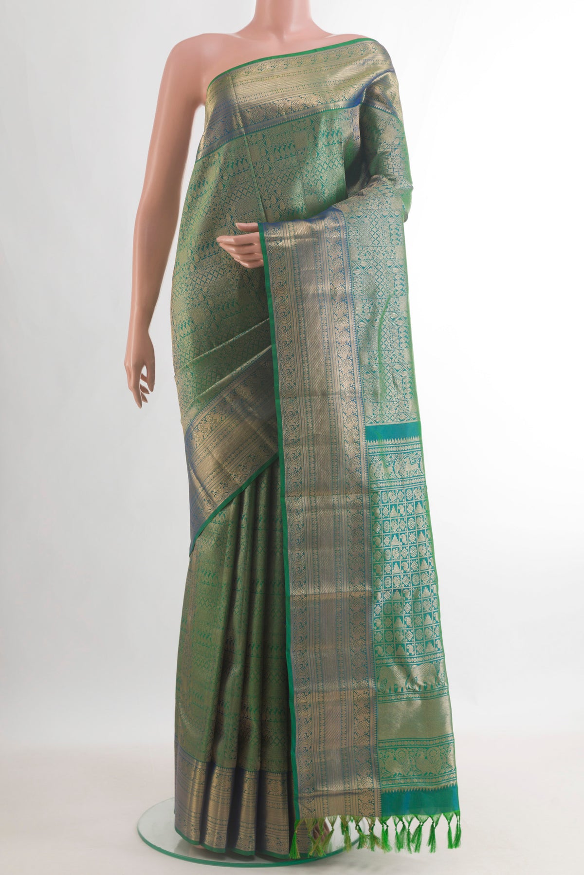 Pure Silk Green Kanchipuram Saree with Zari Brocade on the body and Zari Border.  displayed on a mannequin