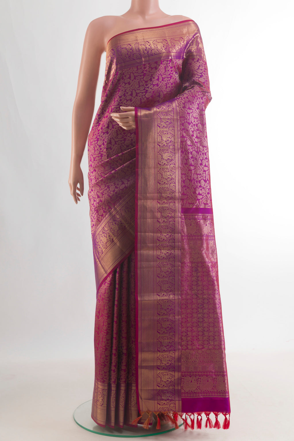 Pure Silk Magenta Kanchipuram Saree with Zari Brocade on the body and Zari Border.  displayed on a mannequin