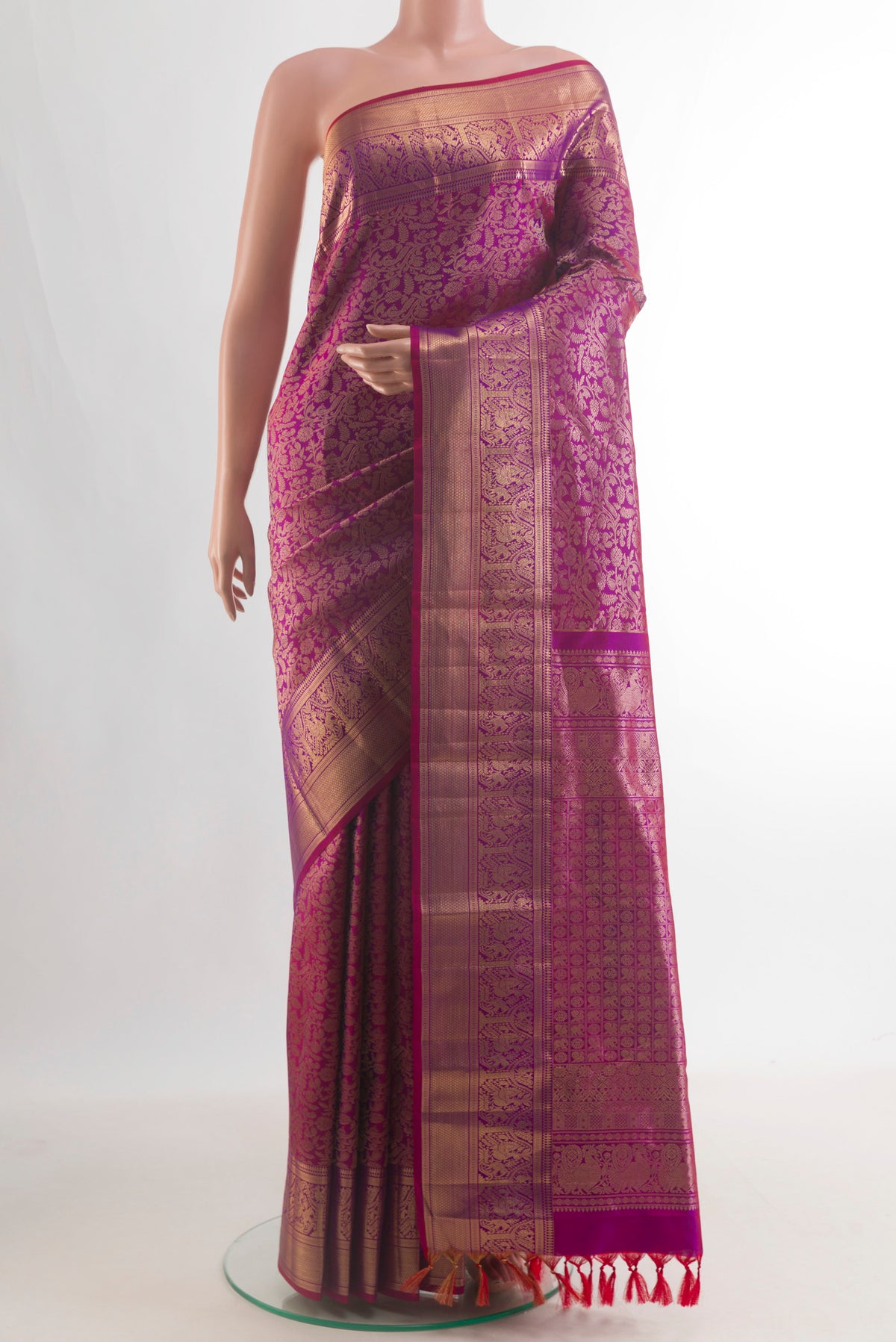 Pure Silk Magenta Kanchipuram Saree with Zari Brocade on the body and Zari Border.  displayed on a mannequin