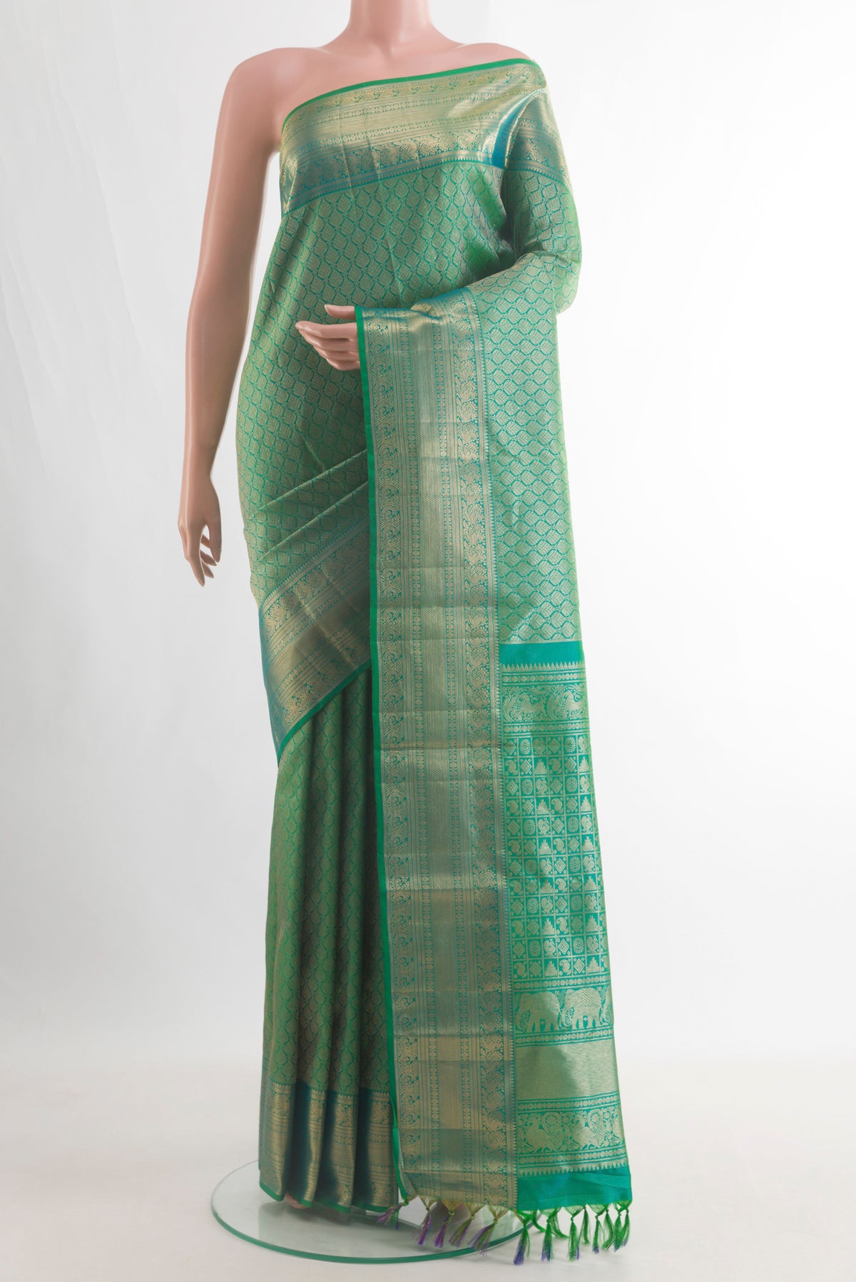 Pure Silk Green Kanchipuram Saree with Zari Brocade on the body and Zari Border.  displayed on a mannequin
