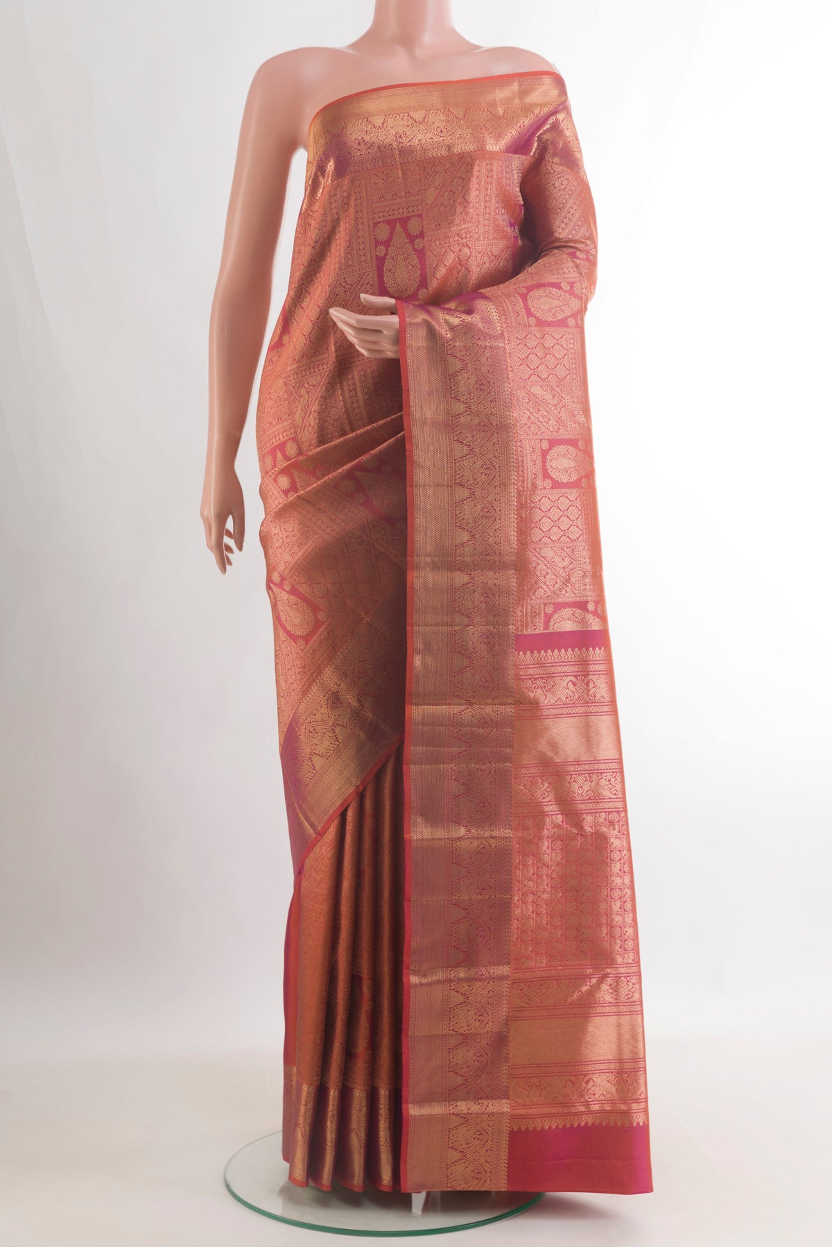 Pure Silk Brick Orange with Magenta Color Kanchipuram Saree with Zari Brocade on the body and Zari Border.  displayed on a mannequin