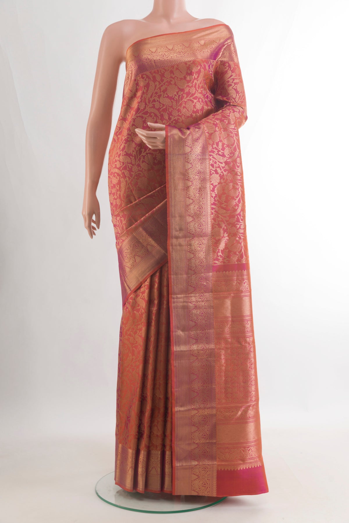 Pure Silk Brick Orange with Magenta Color Kanchipuram Saree with Zari Brocade on the body and Zari Border.  displayed on a mannequin