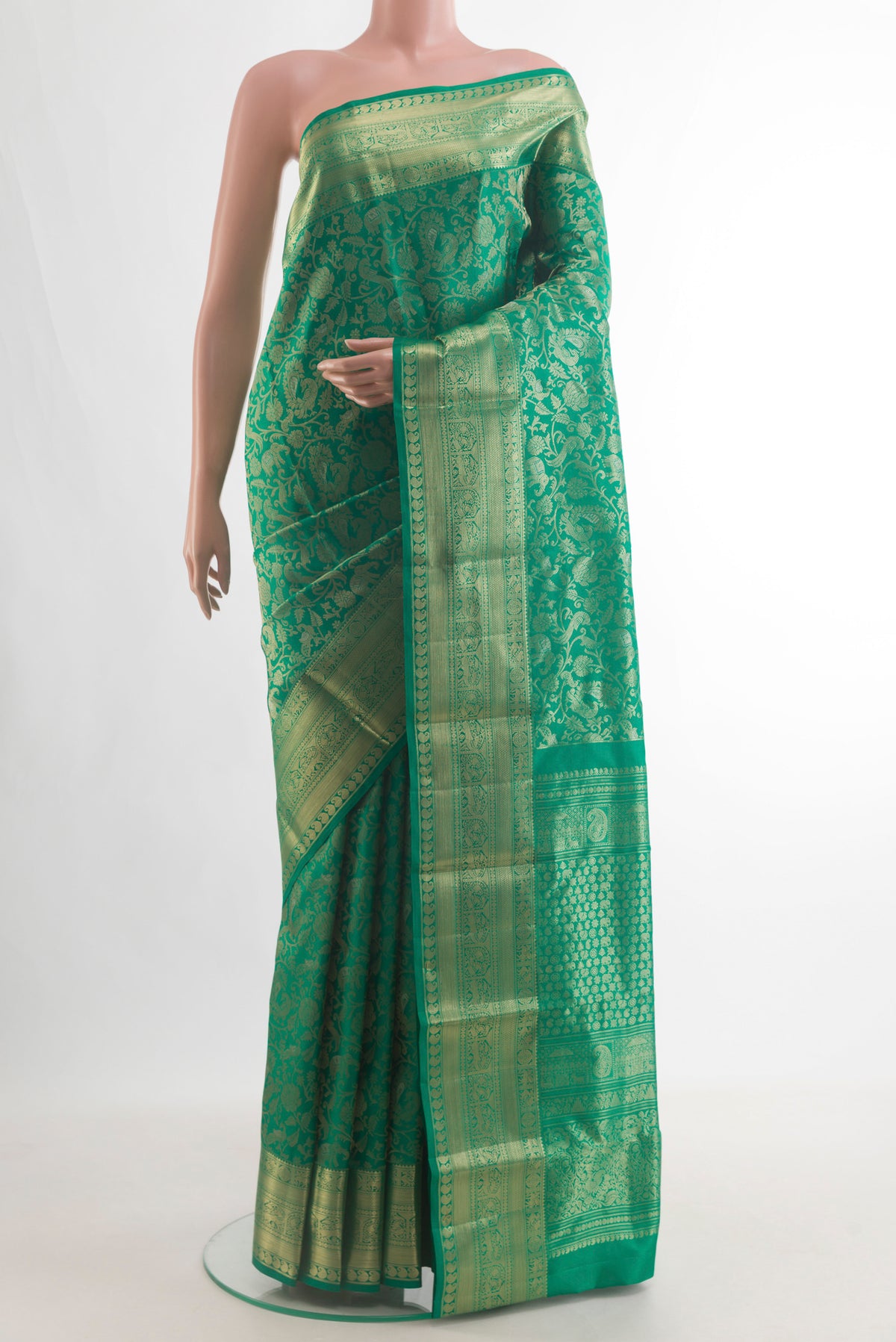 Pure Silk Green Kanjivaram Saree with Zari Brocade on the body and Zari Border.  displayed on a mannequin