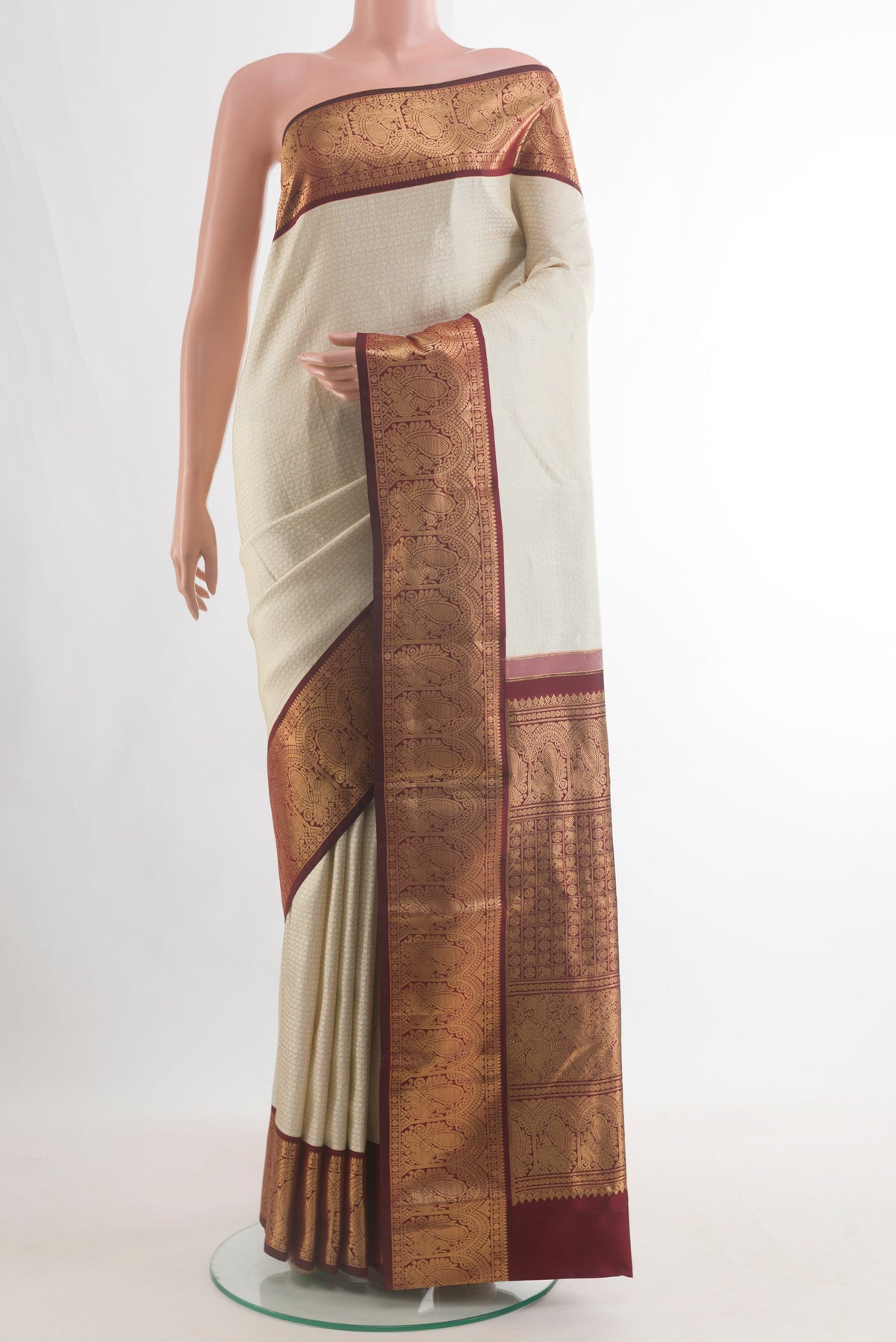 Pure Silk Off White Kanjivaram Saree with Zari Brocade on the body and Zari Border.  displayed on a mannequin