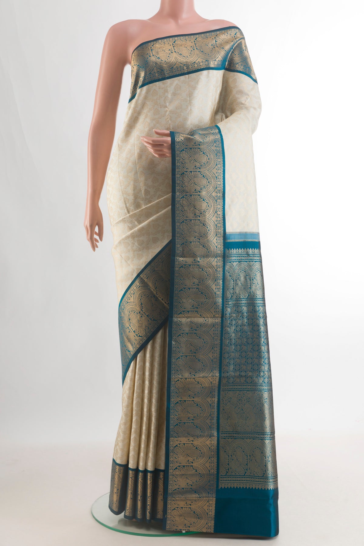 Pure Silk Off White Kanjivaram Saree with Zari Brocade on the body and Zari Border.  displayed on a mannequin