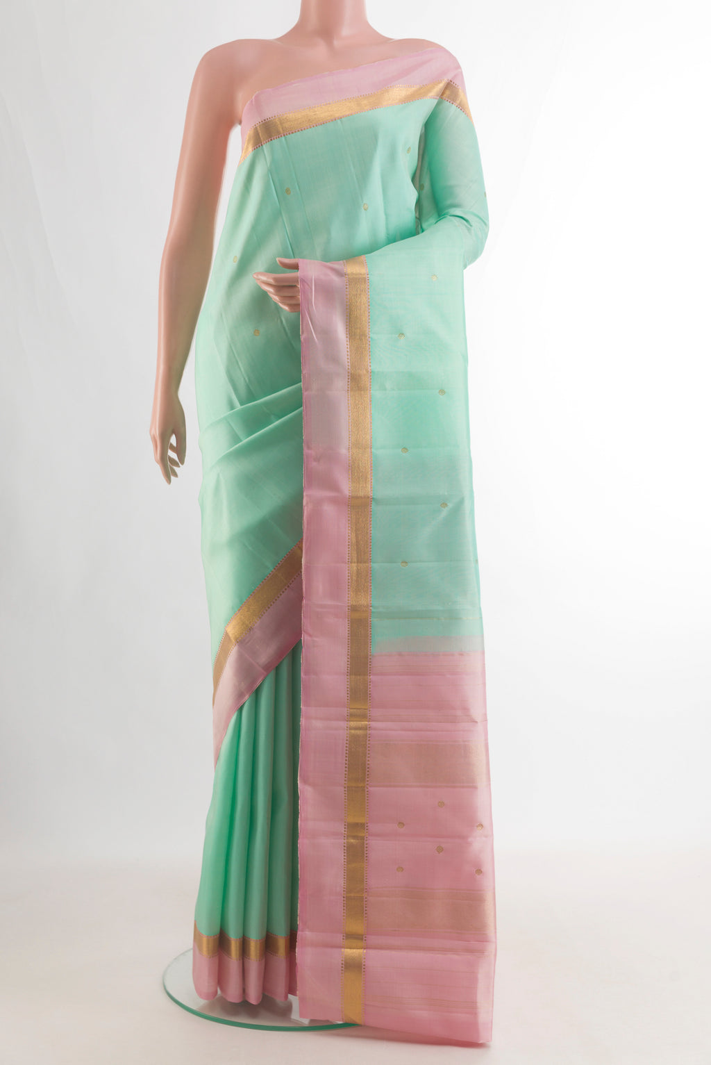 Pure Silk Mint Green Kanchipuram Saree with Zari Butta on the body and Zari Border.  displayed on a mannequin