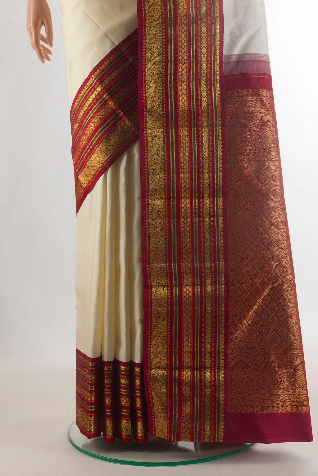 Pleats and pallu of Pure Silk Off White Kanjivaram Saree with Zari Butta on the body and Ganga Jamuna Border. 