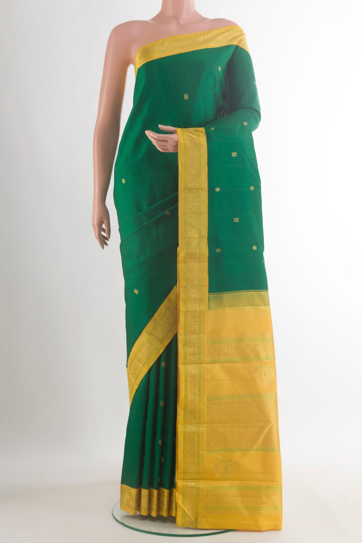Pure Silk Green Kanjivaram Saree with Zari Butta on the body and Zari Border.  displayed on a mannequin