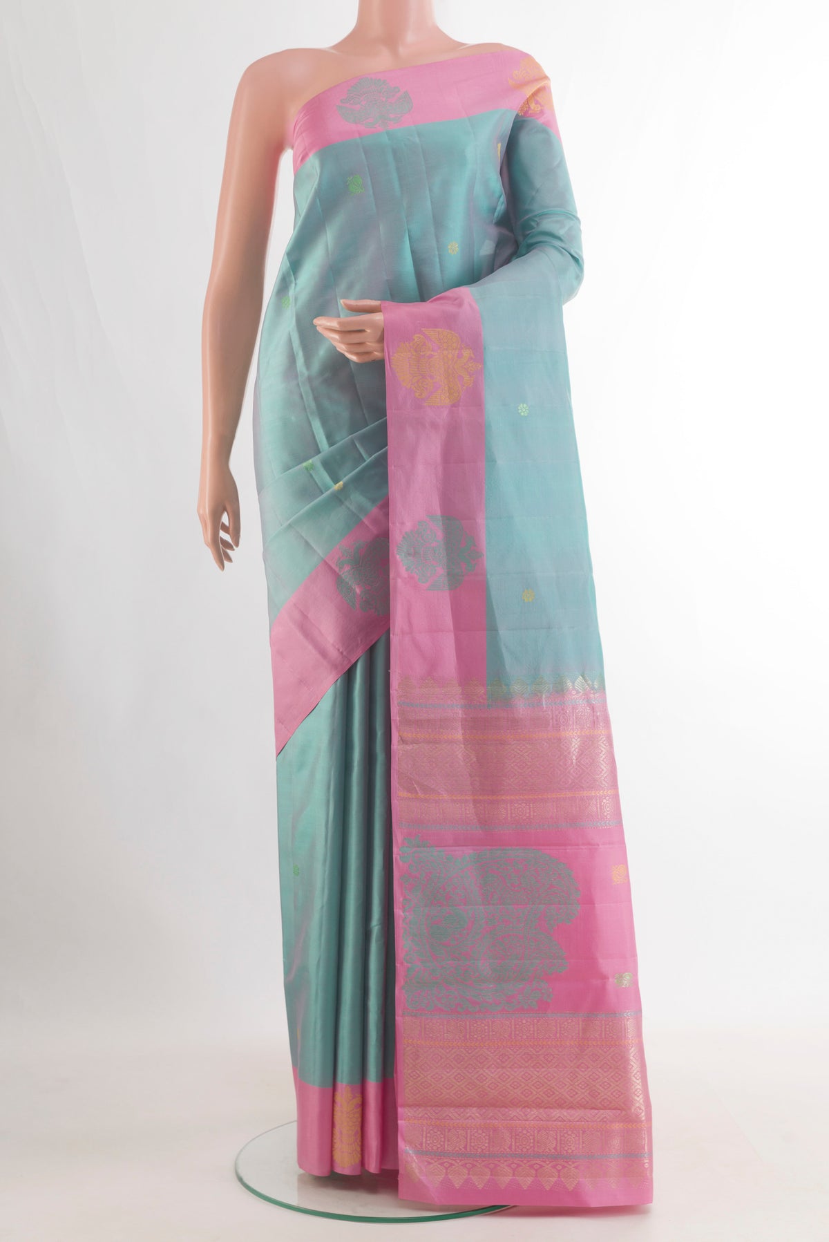 Pure Silk Sea Green Kanchipuram Saree with Zari Butta on the body and Fancy Border.  displayed on a mannequin