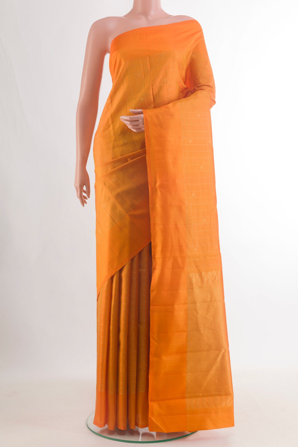 Pure Silk Orange Kanchipuram Saree with Zari Butta on the body and Zari Border.  displayed on a mannequin