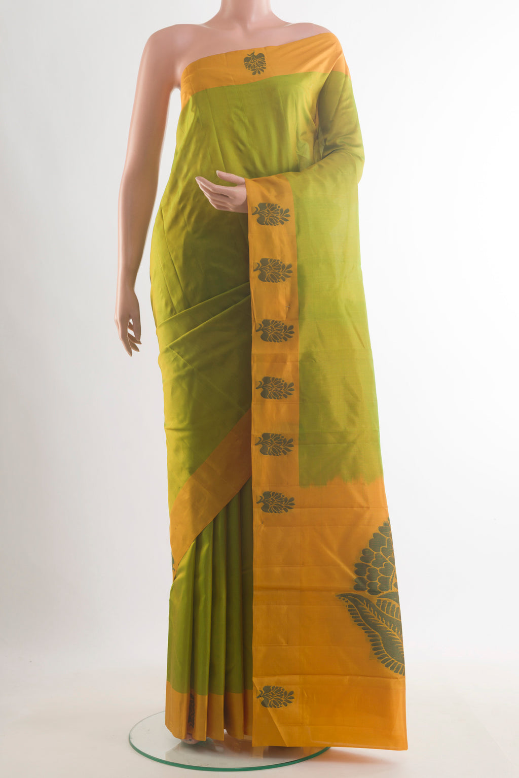 Pure Silk Green Kanjivaram Saree with Plain Body and Thread Border.  displayed on a mannequin