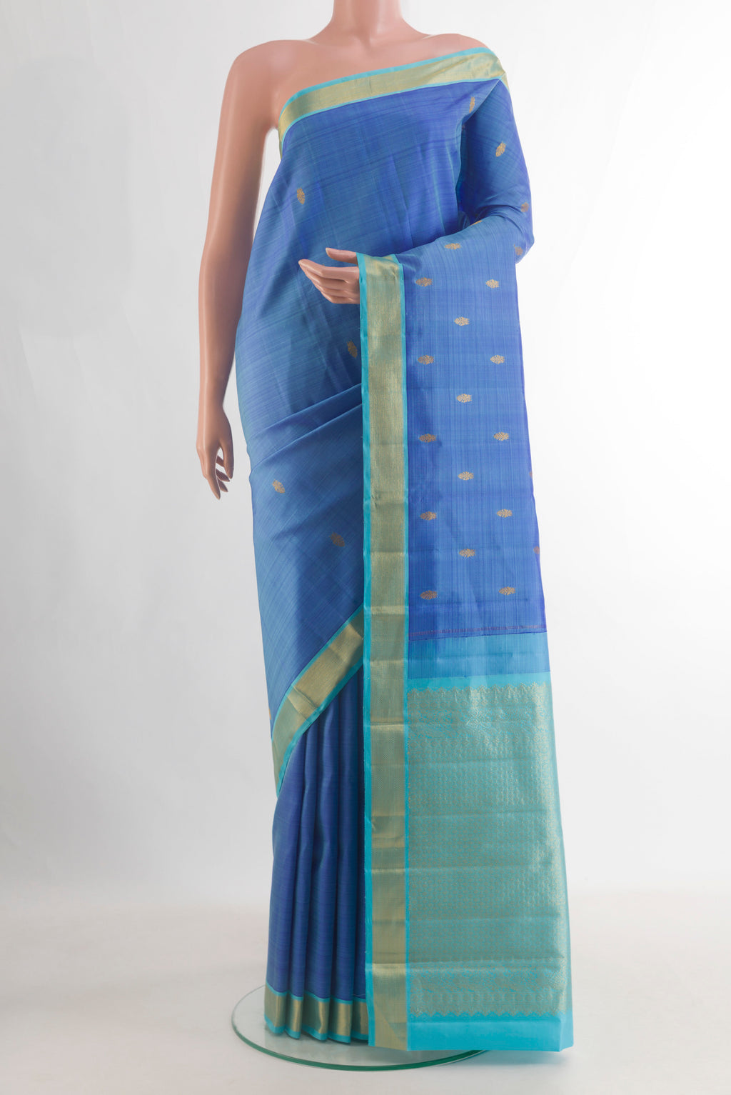 Pure Silk Blue Kanchipuram Saree with Zari Butta on the body and Zari Border.  displayed on a mannequin