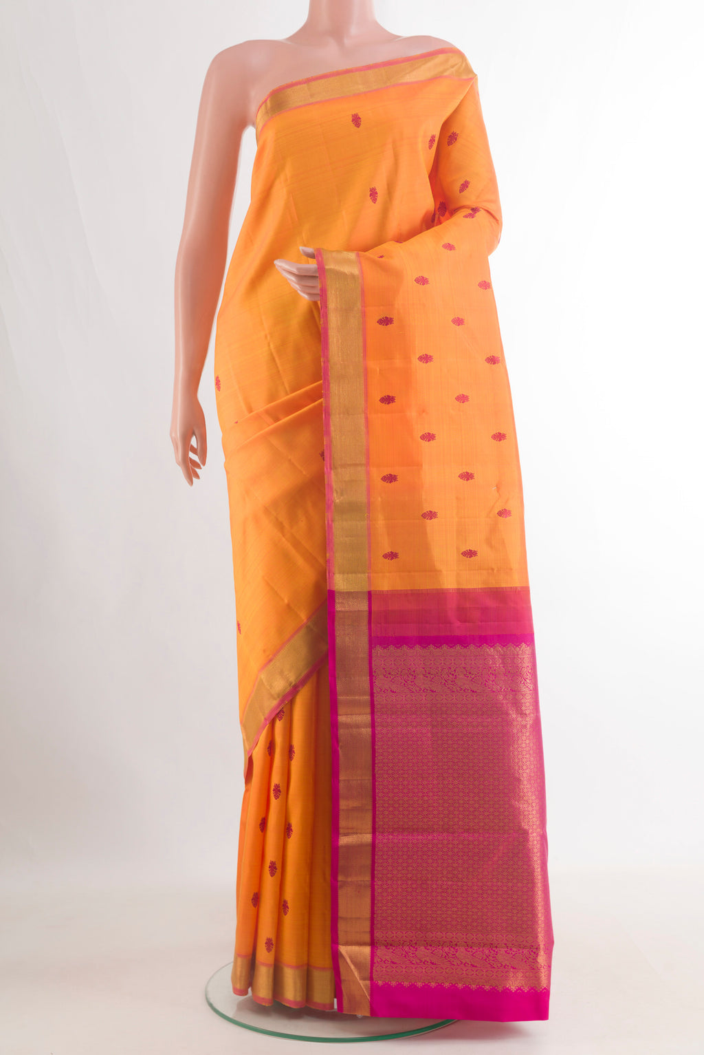 Pure Silk Orange Kanchipuram Saree with Thread Butta on the body and Zari Border.  displayed on a mannequin